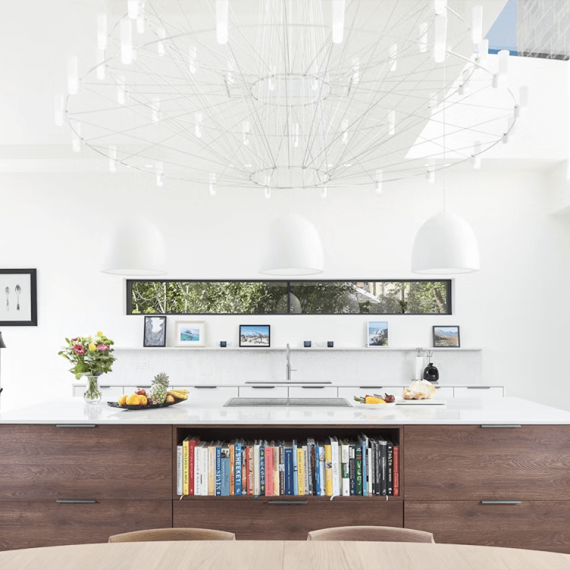 Silestone Lusso countertop sample in a modern white kitchen, showcasing elegant white quartz with subtle veining for a bright and airy kitchen design.