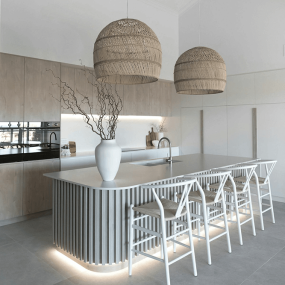 Close-up of a luxurious kitchen island countertop crafted from pristine white quartz, showcasing its smooth, non-porous surface and elegant appearance.