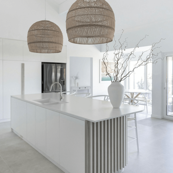 Close-up of a luxurious kitchen island countertop crafted from pristine white quartz, showcasing its smooth, non-porous surface and elegant appearance.