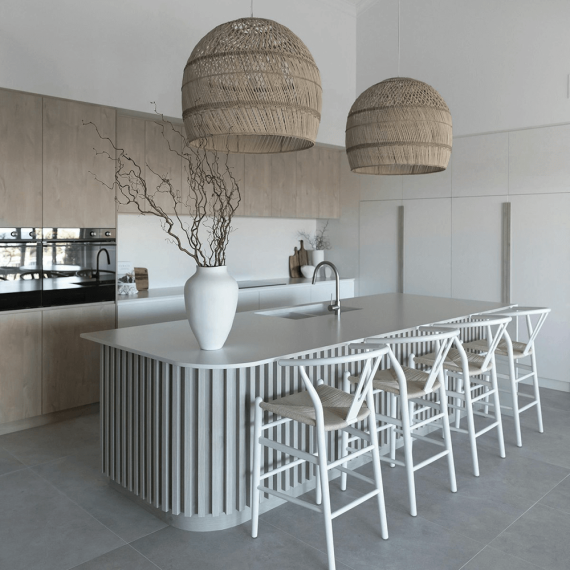 Close-up of a luxurious kitchen island countertop crafted from pristine white quartz, showcasing its smooth, non-porous surface and elegant appearance.