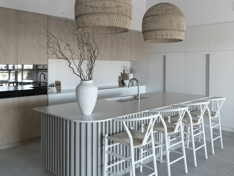 Close-up of a luxurious kitchen island countertop crafted from pristine white quartz, showcasing its smooth, non-porous surface and elegant appearance.
