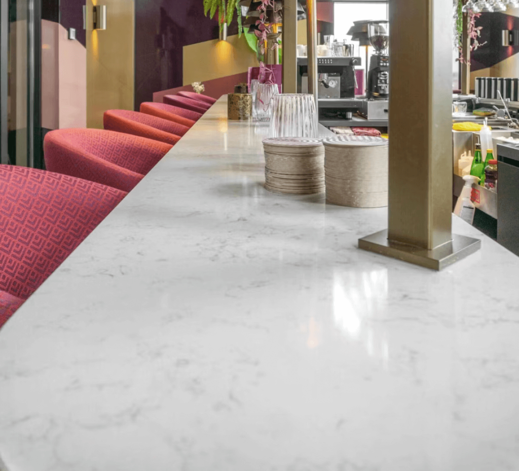 Here are a few alt tag descriptions for the image "Sample application of Lagoon Countertop White Silestone Bar Countertop": Short & Sweet: Silestone Lagoon bar countertop Descriptive: Close-up of a Silestone Lagoon bar countertop, showcasing its elegant white color and subtle veining.