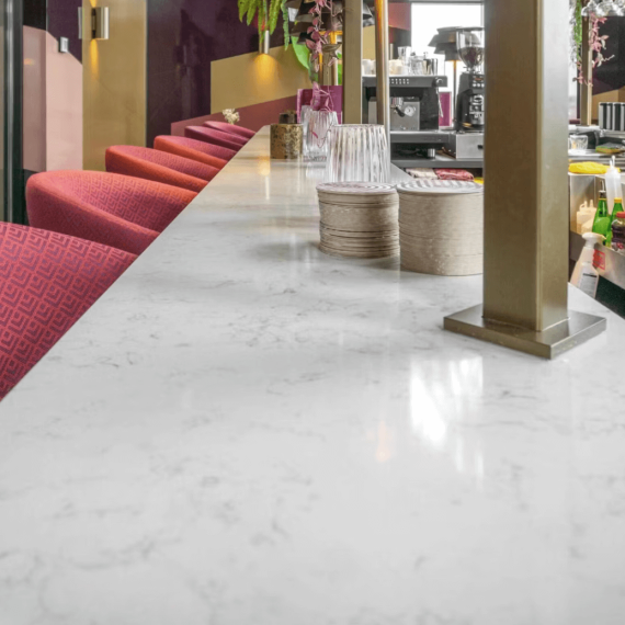 Here are a few alt tag descriptions for the image "Sample application of Lagoon Countertop White Silestone Bar Countertop": Short & Sweet: Silestone Lagoon bar countertop Descriptive: Close-up of a Silestone Lagoon bar countertop, showcasing its elegant white color and subtle veining.