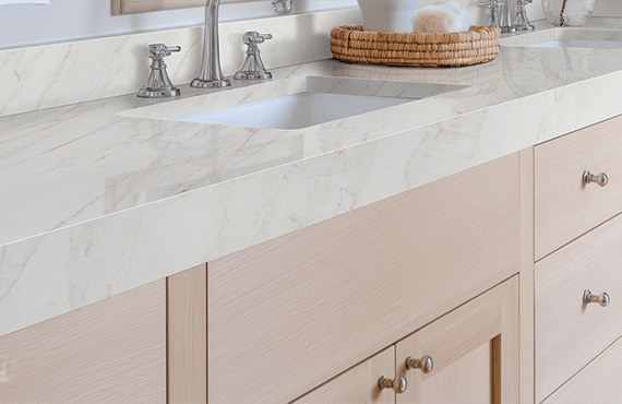 Elegant bathroom vanity featuring Calacatta Premata Premium Natural Quartz, highlighting its beautiful white surface, subtle grey veining, and integrated sink.