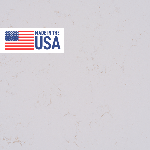 Sample image of Carrara Roma quartz by Daltile featuring delicate grey veining on a bright white background, with a 'Made in USA' badge.